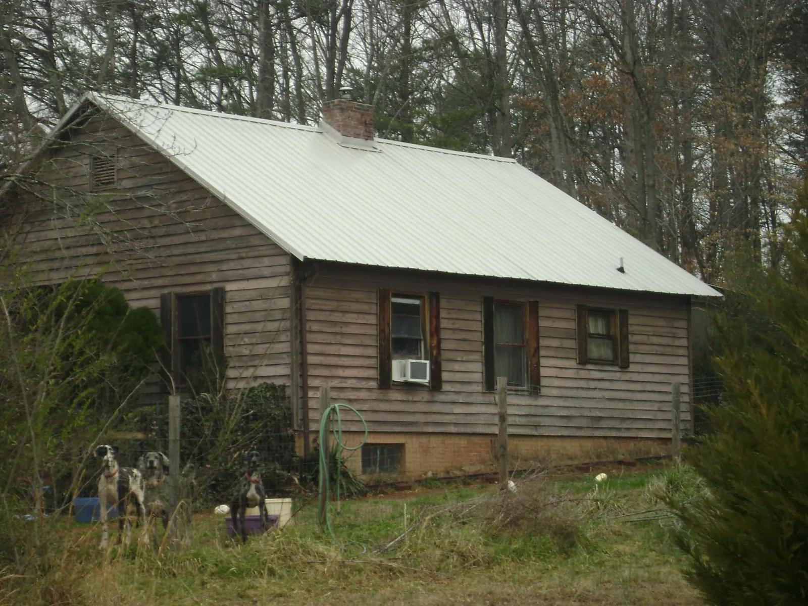 White metal roof on an old wood sided farmhouse, from a Metal Roof Installation job in Entiat